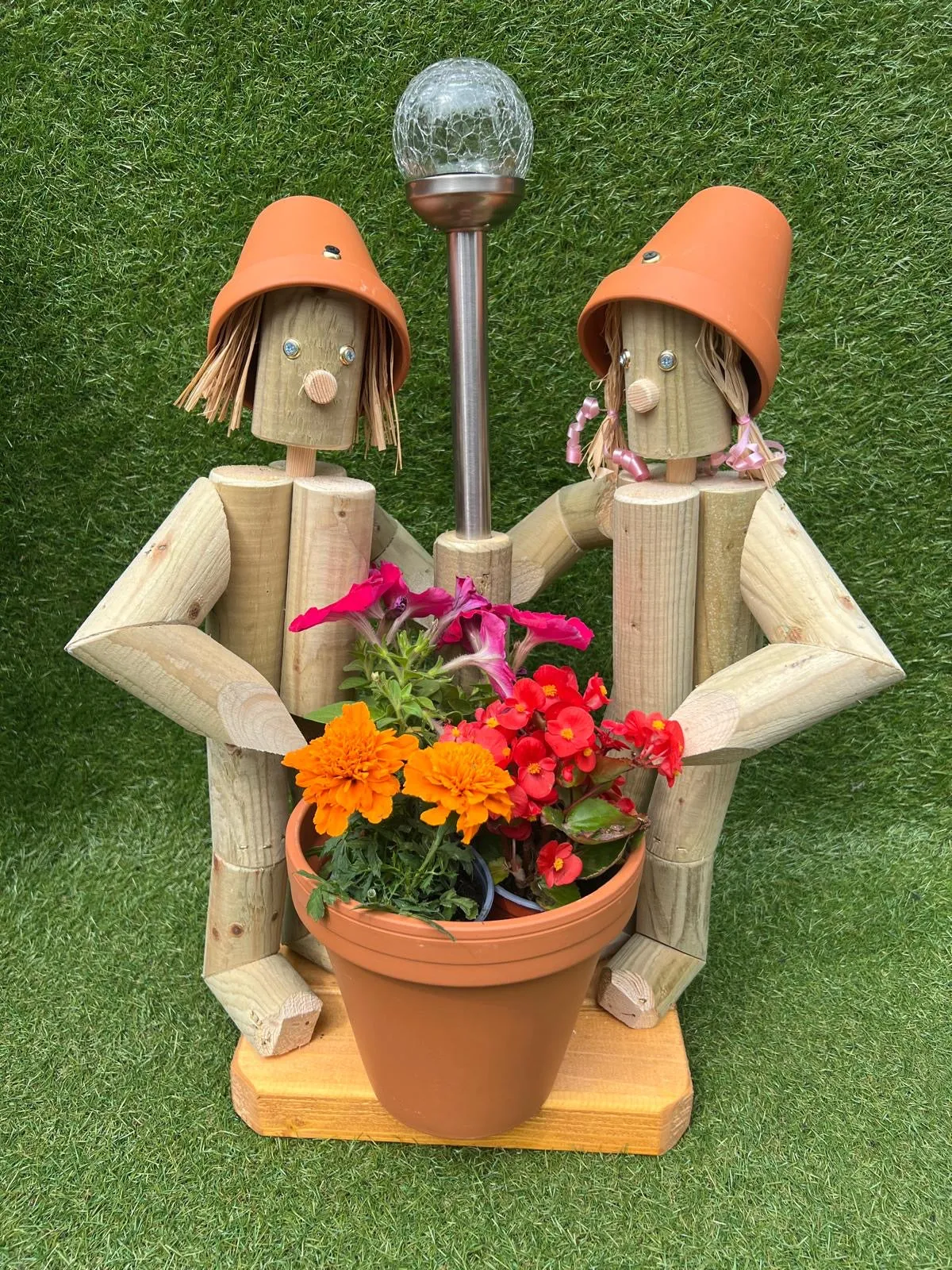 Couple holding a pot with solar light